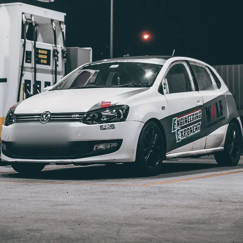 Engineering Exponent Polo GT race car, livery and black wheels, at night