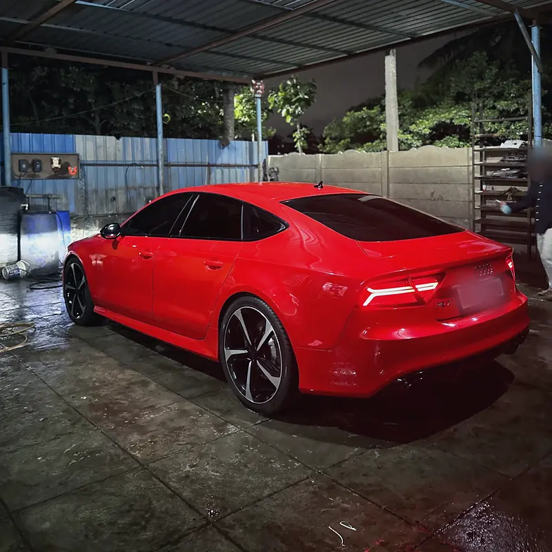 Freshly washed red Audi RS7 under the wash-bay canopy